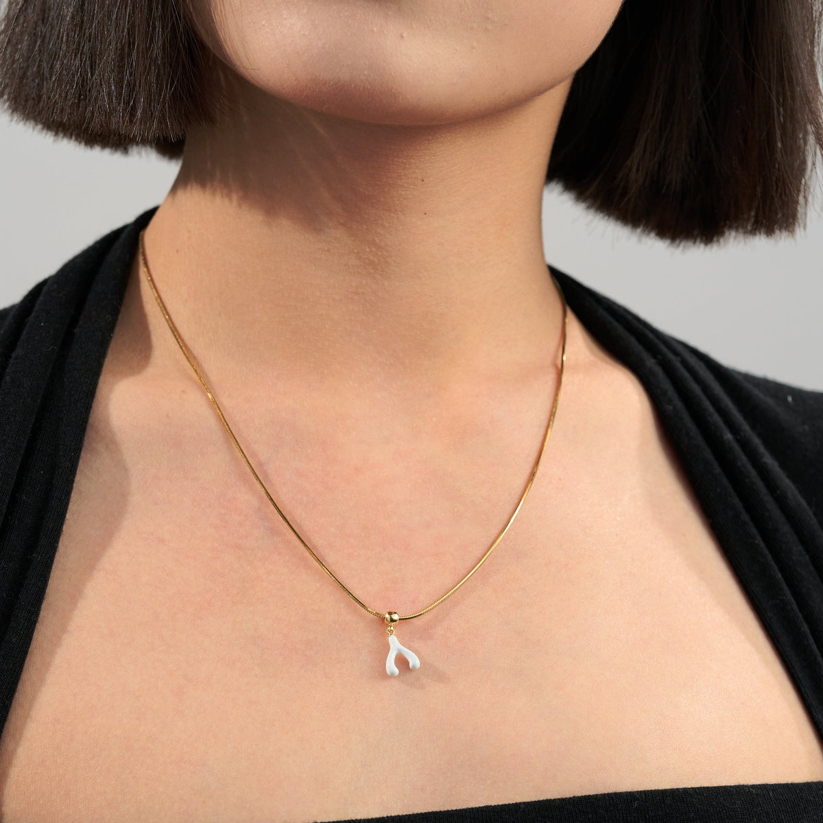 White Enamel Lucky Wishbone Charm — product and styling view 2