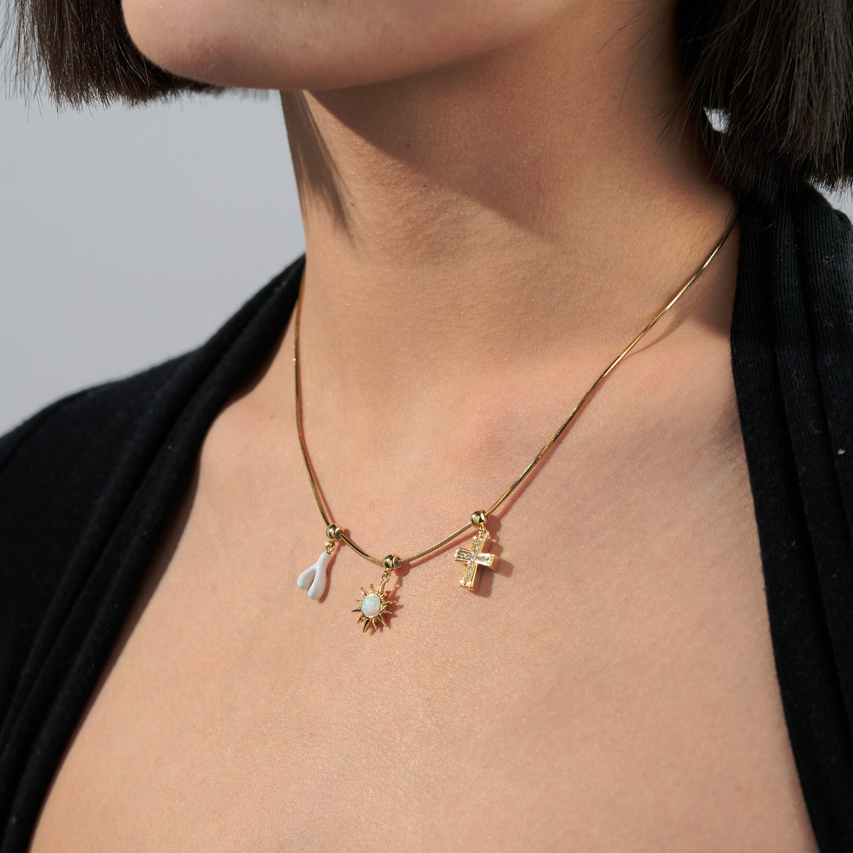 White Enamel Lucky Wishbone Charm — product and styling view 4